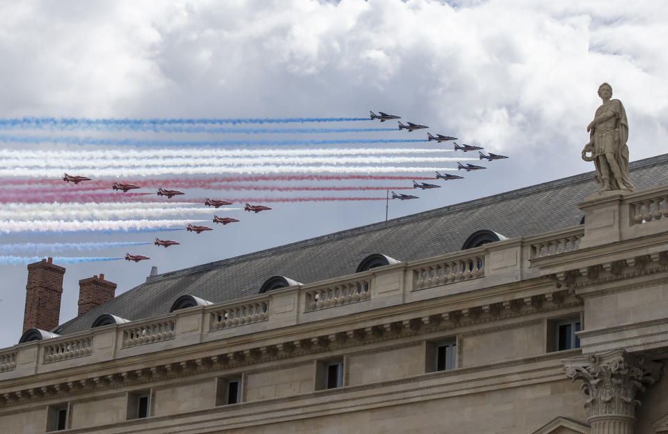French Alpha jets of the Patrouille de France followed by the Red Arrows, officially known as the Royal Air Force Aerobatic Team spray lines of smoke in the colors of the French flag as they flies over Ecole Militaire (military school) in Paris, Thursday, June 18, 2020, to mark the 80th anniversary of late French Gen. Charles de Gaulle's resistance call from London of June 18,1940. (AP Photo/Michel Euler)