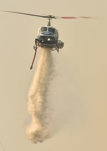 A helicopter drops water on a bushfire in Batemans Bay in New South Wales