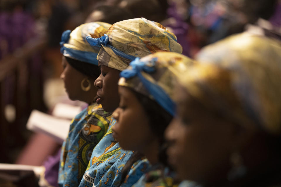 Women pray during a Mass celebrated by Pope Francis for the Congolese Catholic community of Rome, in St. Peter's Basilica at the Vatican Sunday, Dec. 1, 2019. (AP Photo/Alessandra Tarantino)