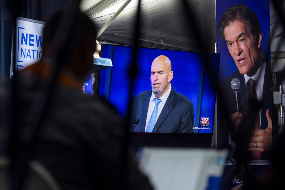 Members of the media watch John Fetterman face off against Mehmet Oz on a TV monitor during the candidates' only debate in Harrisburg, Pa., on Oct. 25.<span class="copyright">Jim Lo Scalzo—EPA-EFE/Shutterstock</span>