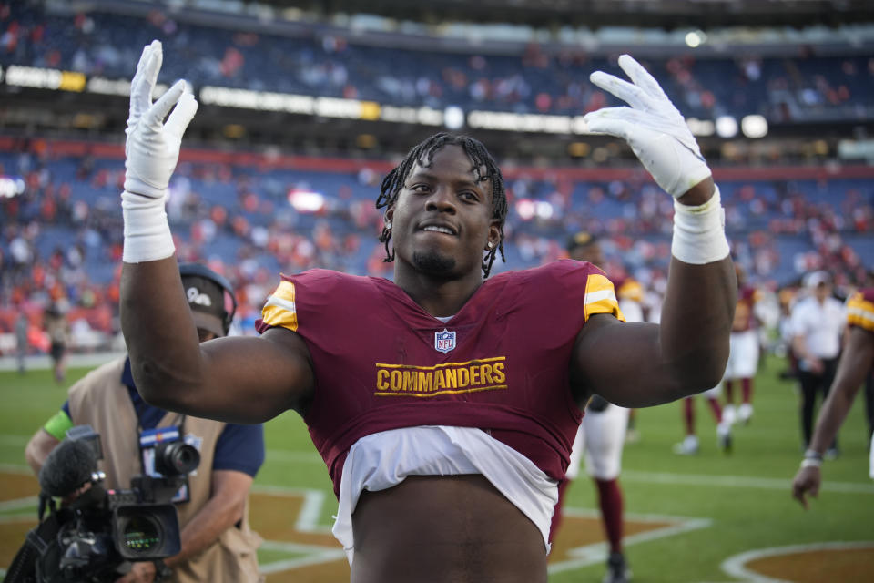 Washington Commanders running back Brian Robinson Jr. gestures to fans as he leaves the field after an NFL football game against the Denver Broncos, Sunday, Sept. 17, 2023, in Denver. (AP Photo/David Zalubowski)