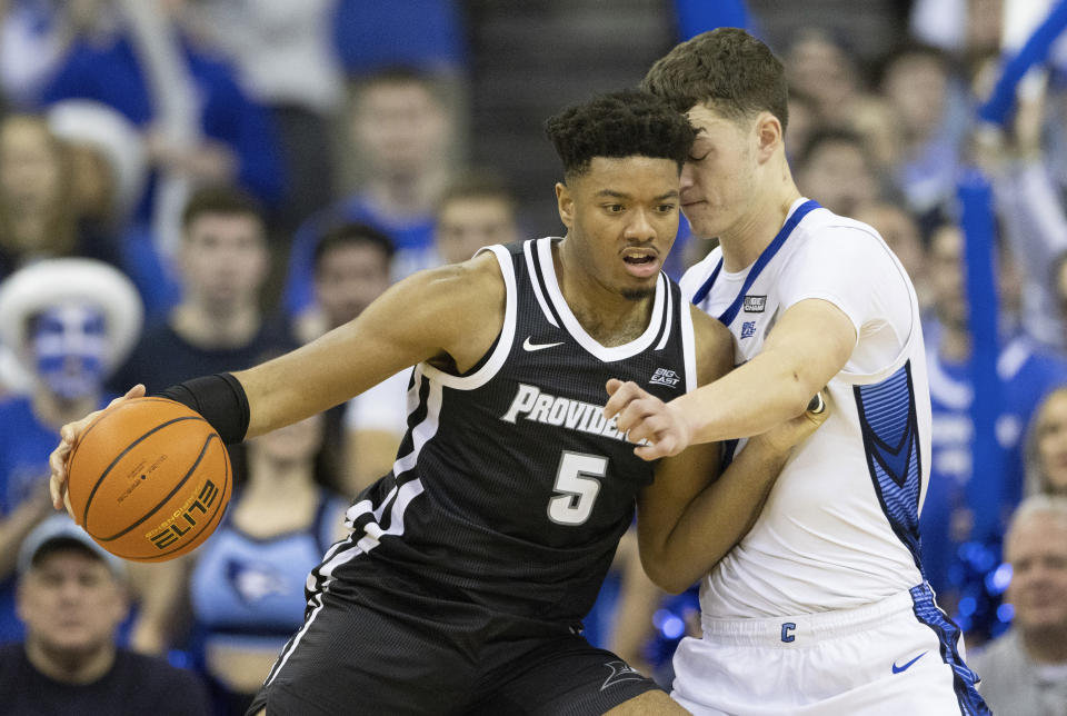 Providence's Ed Croswell, left, drives against Creighton's Ryan Kalkbrenner during the second half of an NCAA college basketball game on Saturday, Jan. 14, 2023, in Omaha, Neb. (AP Photo/Rebecca S. Gratz)
