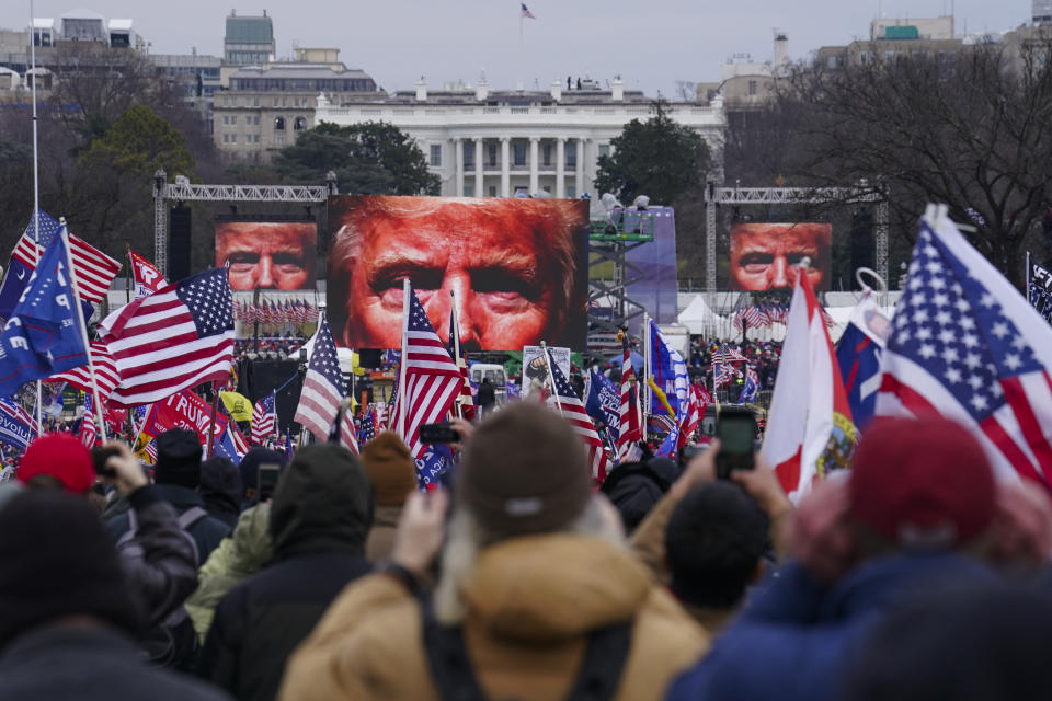 Trump supporters, holding flags and photos of Trump, at a rally in Washington on Jan. 6, 2021.