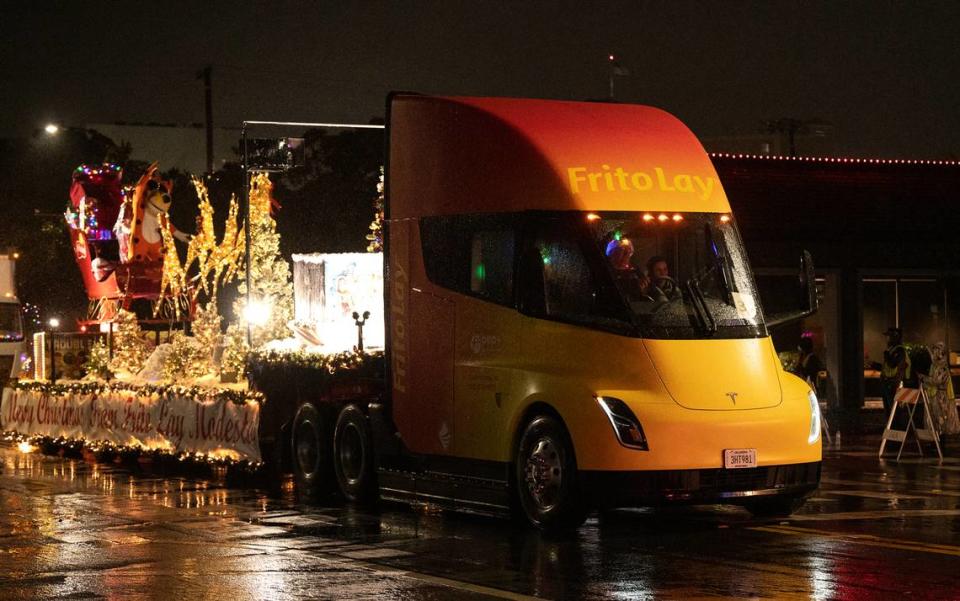 A Frito Lay freight Tesla truck drives in the Celebration of Lights holiday parade in Modesto, Calif., Saturday, Dec. 3, 2022.