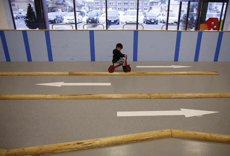 Four-year-old Iori Hiyama rides a tricycle at an indoor playground which was built for children and parents who refrain from playing outside because of concerns about nuclear radiation in Koriyama, west of the tsunami-crippled Fukushima Daiichi nuclear power plant, Fukushima prefecture February 27, 2014. (REUTERS/Toru Hanai)