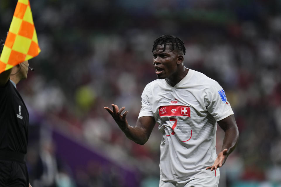 Switzerland's Breel Embolo argues with linesman during the World Cup round of 16 soccer match between Portugal and Switzerland, at the Lusail Stadium in Lusail, Qatar, Tuesday, Dec. 6, 2022. (AP Photo/Manu Fernandez)