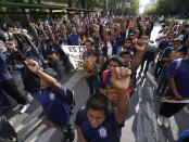 Relatives and classmates of the missing 43 Ayotzinapa college students march in Mexico City, Monday, Sept. 26, 2022, on the day of the anniversary of the disappearance of the students in Iguala, Guerrero in 2014. Three members of the military and a former federal attorney general were recently arrested in the case, and few now believe the government's initial claim that a local drug gang and allied local officials were wholly to blame for seizing and killing the students on July 26, 2014, most of which have never been found. (AP Photo/Marco Ugarte)