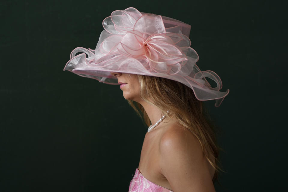 A race fan walks through the grounds of Churchill Downs before the 150th running of the Kentucky Derby horse race Saturday, May 4, 2024, in Louisville, Ky. (AP Photo/Charlie Riedel)