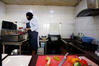 Melanie Igbe, head chef at Cafe de Elyon, prepares food in the kitchen at the cafe in Lekki, Lagos