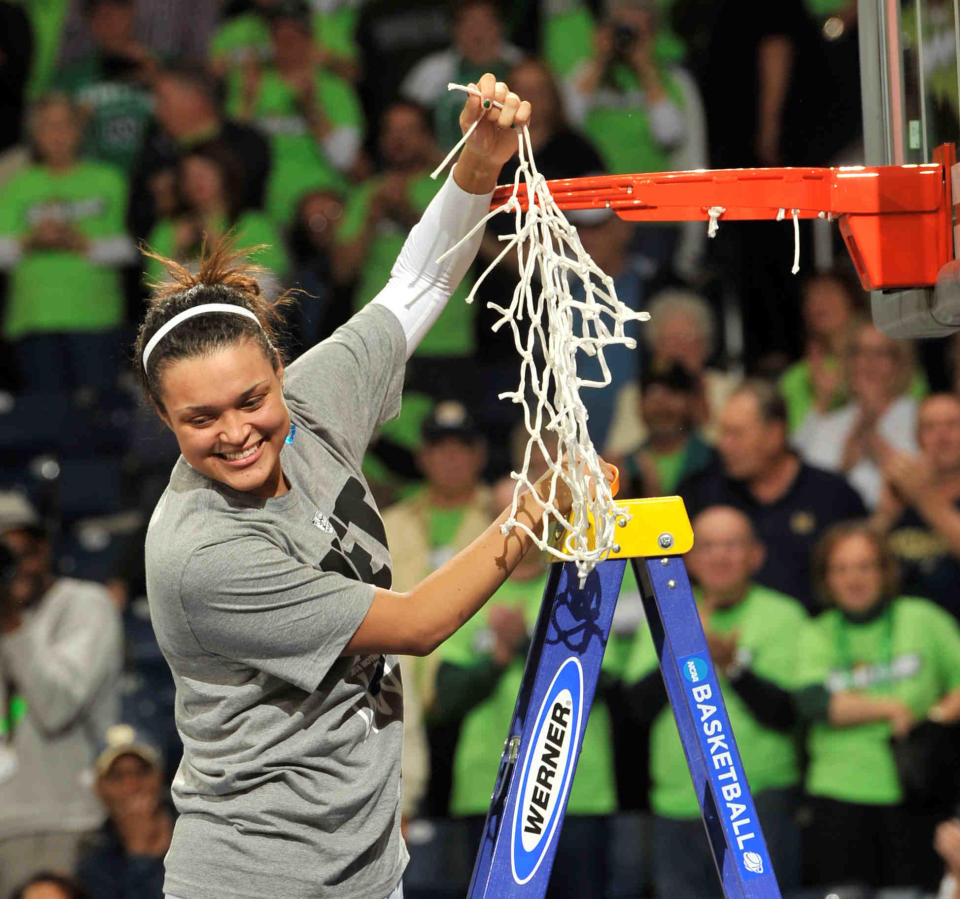 Notre Dame guard Kayla McBride holds a piece of the net after their NCAA women's college basketball tournament regional final game at the Purcell Pavilion in South Bend, Ind Monday March 31, 2014. Notre Dame beat Baylor, 88-69. (AP Photo/Joe Raymond)