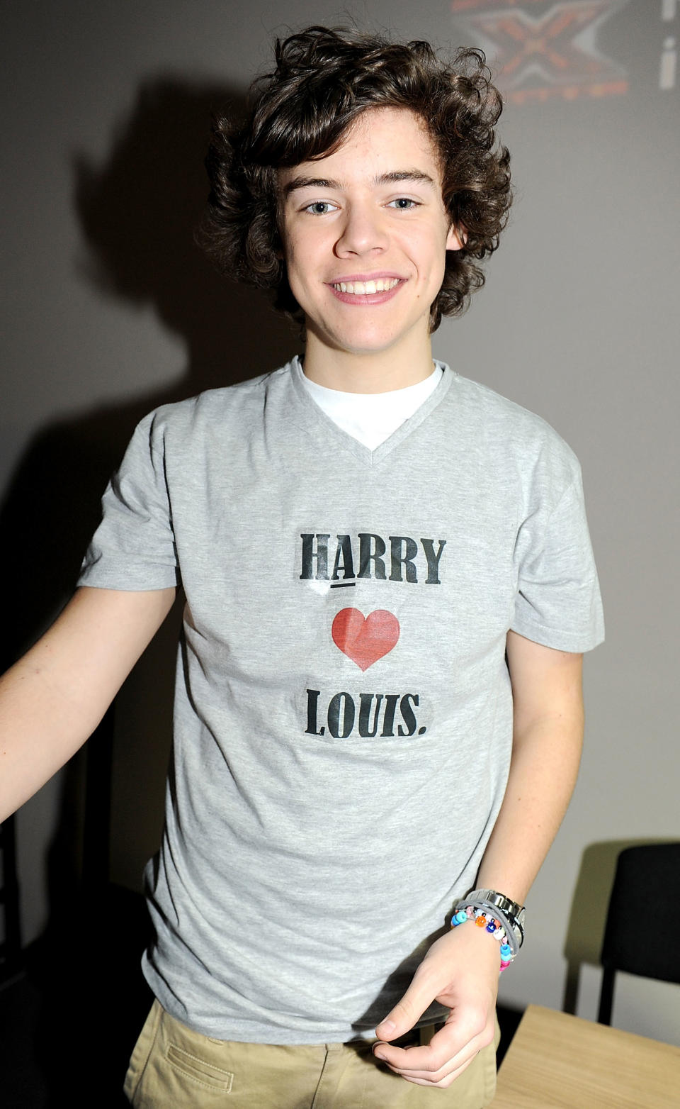 he's wearing a shirt that reads harry hearts louis