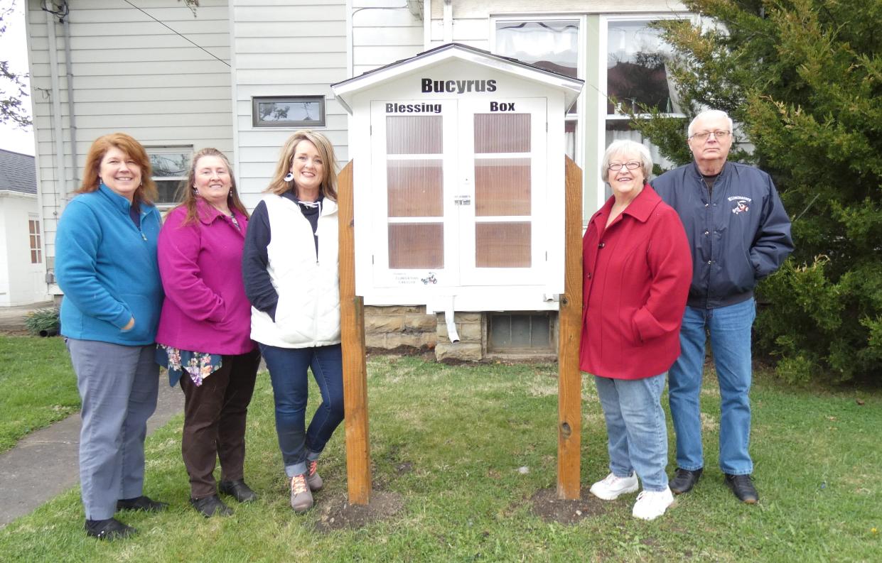 Paula Brown, Tabetha Linn, Miki Zeigler, Mary Jo Carle and Bob Carle stand next to the new Bucyrus Blessing Box, which is on Swigart Street, in the west lawn of the BORN office at 222 E. Rensselaer St.
