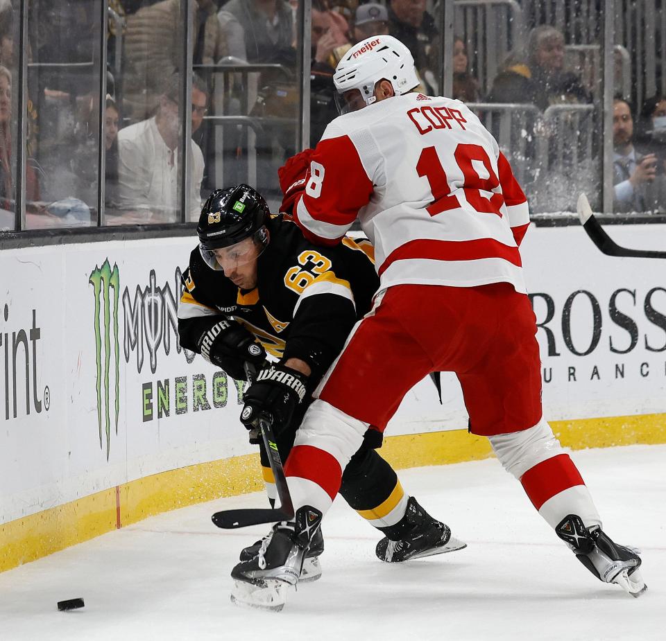 Boston Bruins left wing Brad Marchand (63) tries to get around Detroit Red Wings center Andrew Copp (18) during the first period at TD Garden in Boston on Saturday, March 11, 2023.