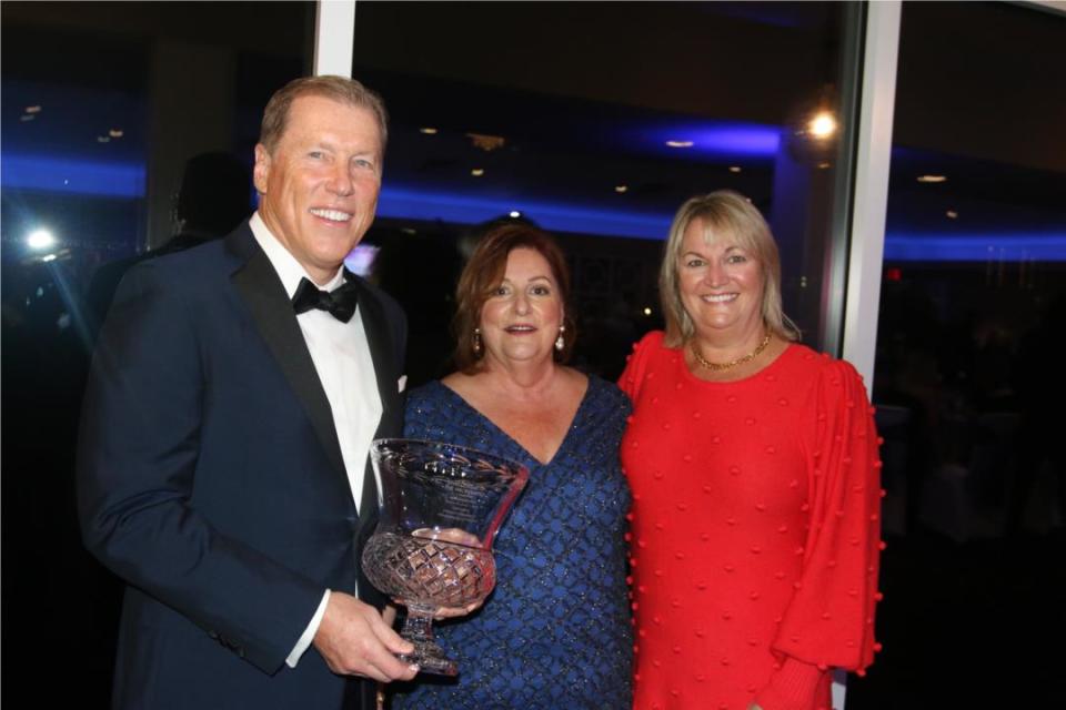 Charlie Lydecker, the CEO of Foundation Risk Partners, holds the J. Saxton Lloyd Distinguished Community Service Award for 2021 that he a received at the Civic League of the Halifax Area's annual dinner meeting at Oceanside Country Club in Ormond Beach on March 4, 2022. Also pictured: Mary Greenlees, center, Civic League chair from 2019-2021, and Lydecker's wife Chris.