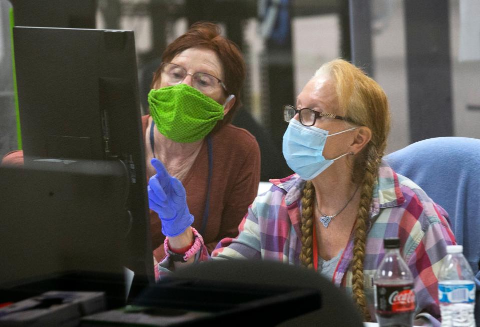 Maricopa County Elections adjudicators check ballots that have individual contests in question to determine the voters intent at the Maricopa County Elections headquarters in Phoenix, Ariz., on Nov. 12, 2020. The adjudicators work in pairs, a registered Republican and a registered Democrat.