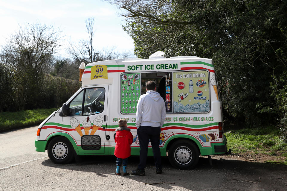 AYLESBURY VALE, ENGLAND - MARCH 22: A family enjoy an ice cream at Coombe Hill on March 22, 2020 in Aylesbury Vale, Buckinghamshire. Coronavirus (COVID-19) has spread to at least 188 countries, claiming over 13,000 lives and infecting more than 300,000 people. There have now been 5,018 diagnosed cases in the UK and 240 deaths. (Photo by Catherine Ivill/Getty Images)