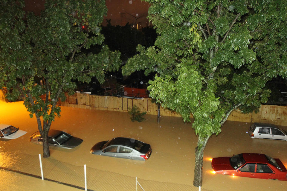 Cars are seen submerged by floodwaters in George Town