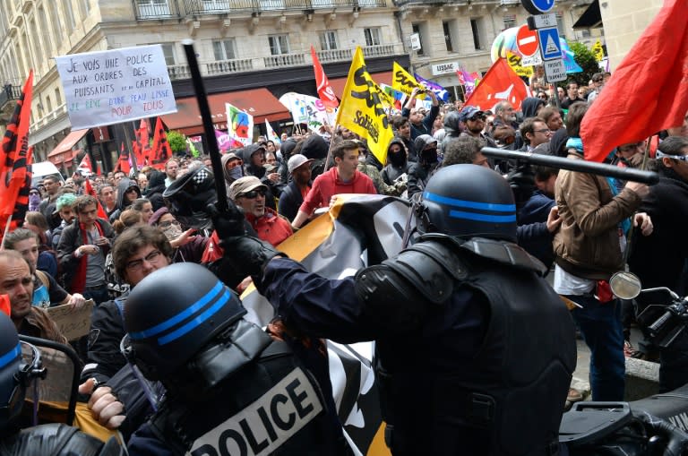 Security forces clash with demonstrators during a protest called by labour unions and students against the labour and employment law reform on May 26, 2016 in Bordeaux