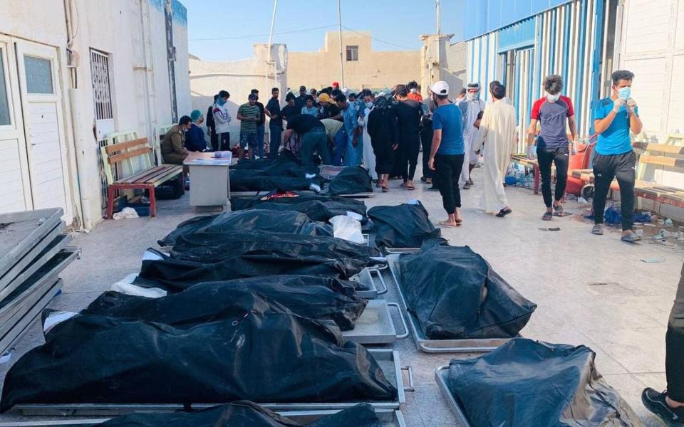 Photo by HAIDER AL-ASSADEE/EPA-EFE/Shutterstock (12210774i) Iraqis stand next to the coffins of victims outside a hospital morgue at Nasiriyah city, 360 km southern Baghdad, Iraq on 13 July 2021. At least 64 people died and dozens were injured when a fire broke out following the explosion of oxygen tanks at an isolation center for Covid-19 patients in the city of Nasiriyah on late 12 July 2021, Medical and security sources said. At least 64 killed and dozens injured in a fire at an isolation center for Covid-19 patients in Iraq, Nasiriyah - 13 Jul 2021 - Shutterstock