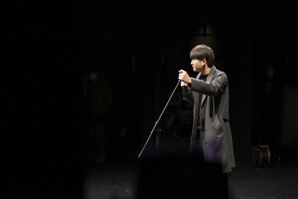 In this photo provided by Guo Jia, a businessman who runs a comedy club in Tokyo, Guo performs standup in Tokyo, Monday, Jan. 9, 2023. (Courtesy of Guo Jia via AP)