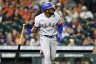 Texas Rangers' Adolis Garcia flips his bat as he watches his home run against the Houston Astros during the eighth inning of a baseball game Friday, May 14, 2021, in Houston. (AP Photo/Michael Wyke)