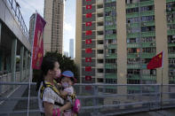 Chinese and Hong Kong flags are hanged to celebrate the 25th anniversary of Hong Kong handover to China, in Hong Kong, Thursday, June 23, 2022. As the former British colony marks the 25th anniversary of its return to China, reeling from pandemic curbs that devastated business and a crackdown on its pro-democracy movement, Hong Kong leaders say it is time to transform again and become a tech center that relies more on ties with nearby Chinese factory cities than on global trade. (AP Photo/Kin Cheung)