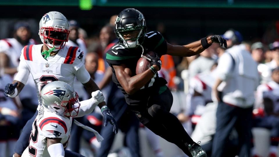 New York Jets wide receiver Garrett Wilson  runs with the ball against the New England Patriots.