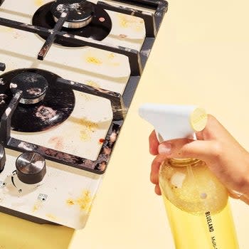 A close-up of the cleaner cleaning a stove