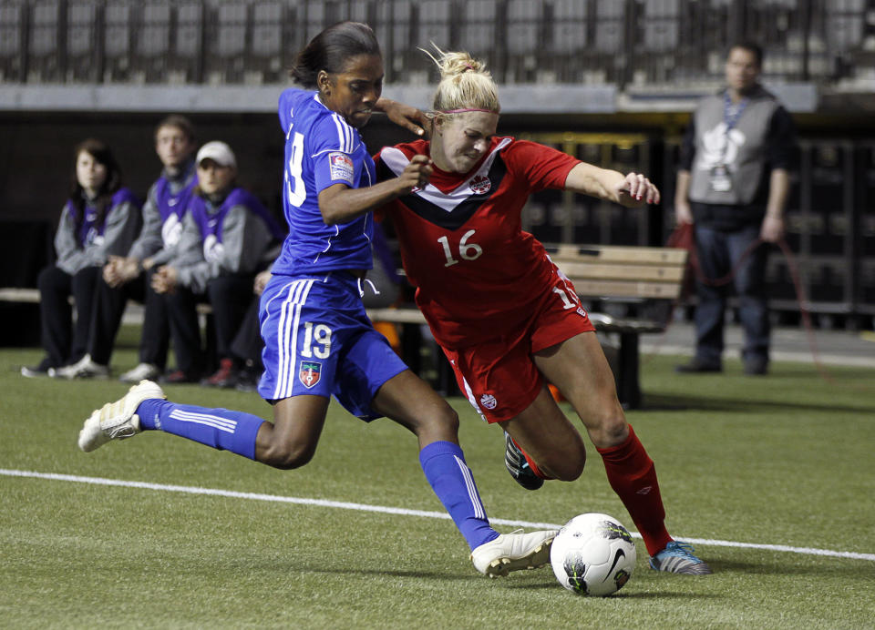 VANCOUVER, CANADA - JANUARY 19: Lauren Sesselmann #16 of Canada collides with Nadia Valentin #19 of Haiti during the 2012 CONCACAF Womenâ€™s Olympic Qualifying Tournament at BC Place on January 19, 2012 in Vancouver, British Columbia, Canada. (Photo by Jeff Vinnick/Getty Images)