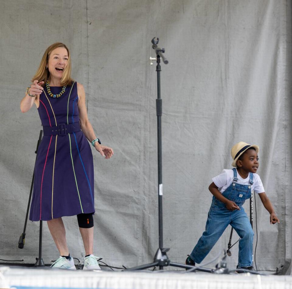 McLean dances with Jayden Kitamba, 5, whose family is from The Republic of the Congo, during a June celebration of World Refugee Day at Grove Plaza.