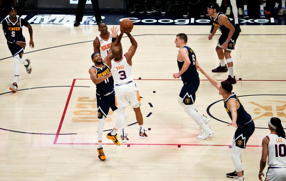 Phoenix Suns guard Chris Paul (3) shoots a jumper against Denver Nuggets forward Bruce Brown (11) in the third quarter during Game 2 of the Western Conference Semifinals at Ball Arena in Denver on May 1, 2023.