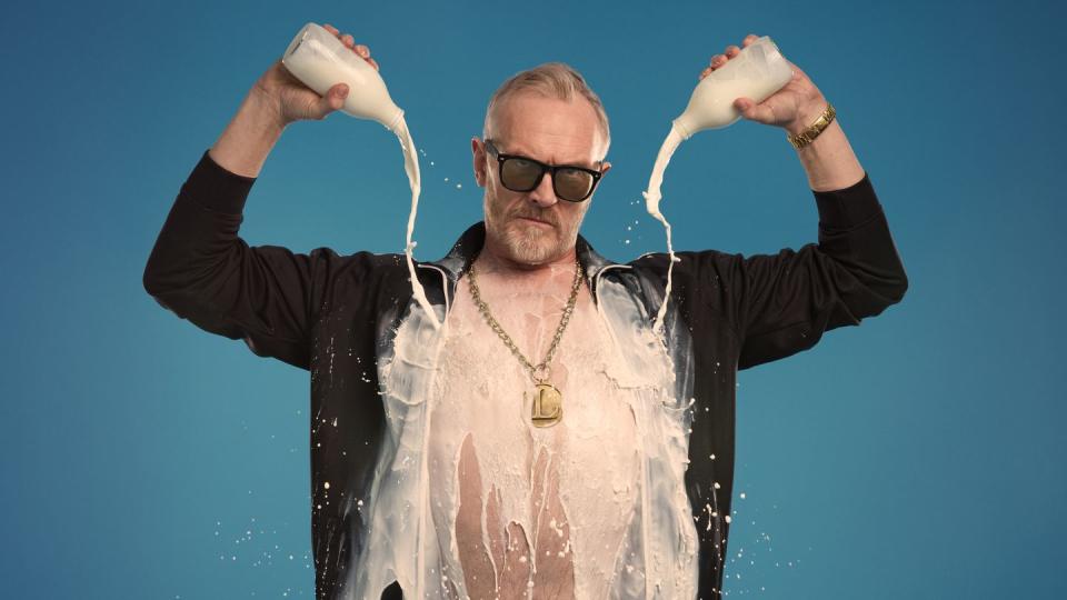 greg davies pouring milk over his chest and shirt in promotional pic for full fat legend comedy tour