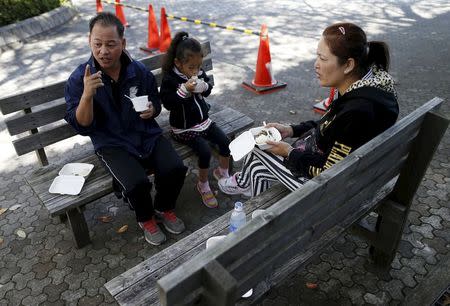 Ol Nishimura, a 51-year-old former Cambodian refugee, has lunch with his family during Asia Sports Festa in Yokohama, south of Tokyo, Japan, October 25, 2015. Picture taken October 25, 2015. REUTERS/Yuya Shino
