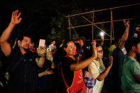 <p>Onlookers cheer as ambulances transport rescued schoolboys from a helipad to a hospital on July 9, 2018, in Chiang Rai, Thailand. Videos released by Thai navy SEALs showed the boys, aged 11 to 16, and their 25-year-old coach are in good health. (Photo: Lauren DeCicca/Getty Images) </p>