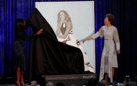 Artist Amy Sherald (R) and former first lady Michelle Obama participate in the unveiling of Mrs. Obama's portrait at the Smithsonianâ€™s National Portrait Gallery in Washington - Credit: Reuters