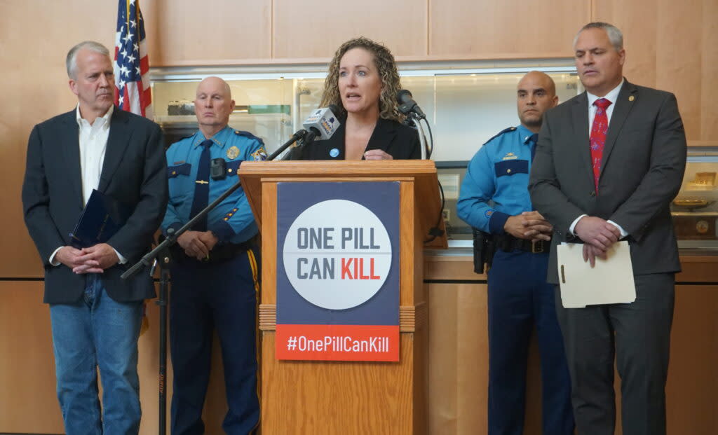 Heidi Hedberg, commissioner of the Alaska Department of Health, speaks at a May 9, 2024, news conference about Alaska's overdose deaths and efforts to educate the public about the dangers of fentanyl. With her are Sen. Dan Sullivan, R-Alaska, and Attorney General Treg Taylor. (Photo by Yereth Rosen/Alaska Beacon)