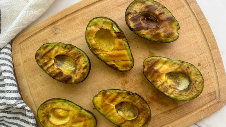 charred avocados on board