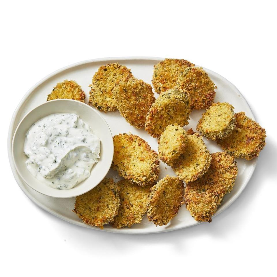 <p>These crispy bites are baked instead of fried for an easier (and healthier!) take on a popular snack.</p><p>Get the <a href="https://www.womansday.com/food-recipes/a30393766/crispy-ranch-pickles-recipe/" rel="nofollow noopener" target="_blank" data-ylk="slk:Crispy Ranch Pickles recipe;elm:context_link;itc:0;sec:content-canvas" class="link "><strong>Crispy Ranch Pickles recipe</strong></a> from Woman's Day.</p>