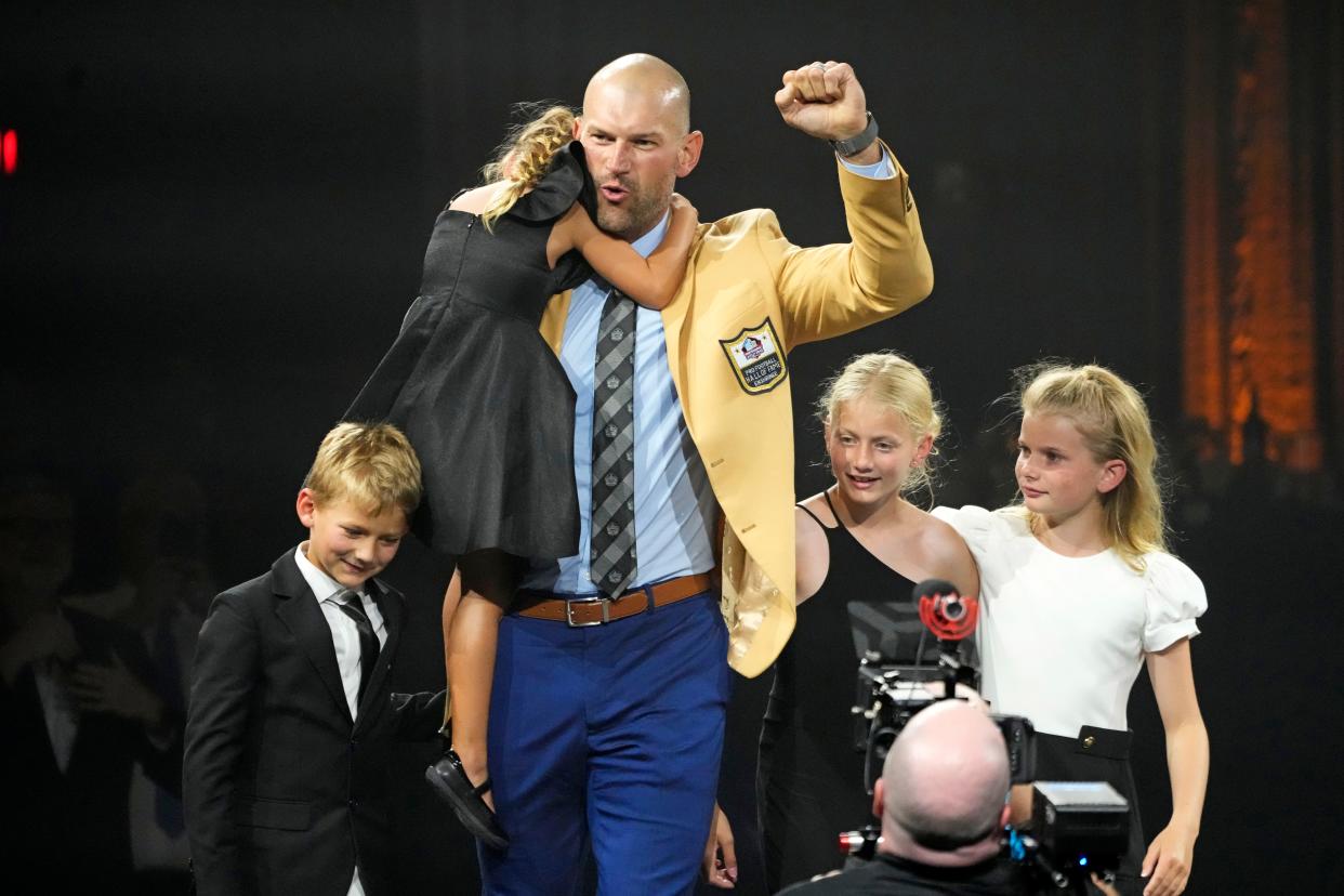 Joe Thomas, a member of the Pro Football Hall of Fame Class of 2023, is joined by his children after receiving his gold jacket Friday in Canton.