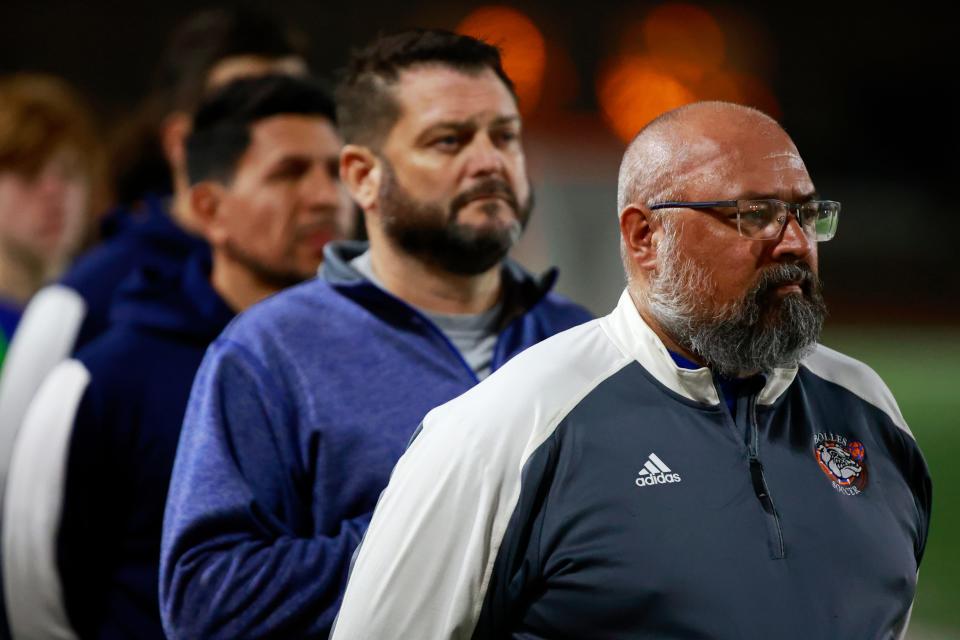 From right, Bolles head coach Jim Lieb, assistant coach Joey Barrett and assistant coach Diego Velasquez stand for the national anthem before a February boys soccer playoff against Pensacola Catholic. Lieb, in his 24th season at Bolles, won his 400th game last week.