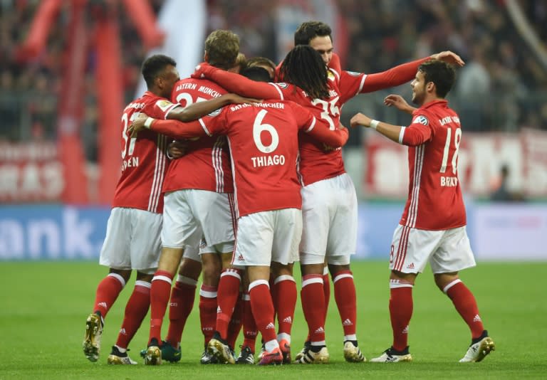 Bayern Munich players celebrate after Philipp Lahm scores the opening goal against Augsburg in Munich, southern Germany on October 26, 2016