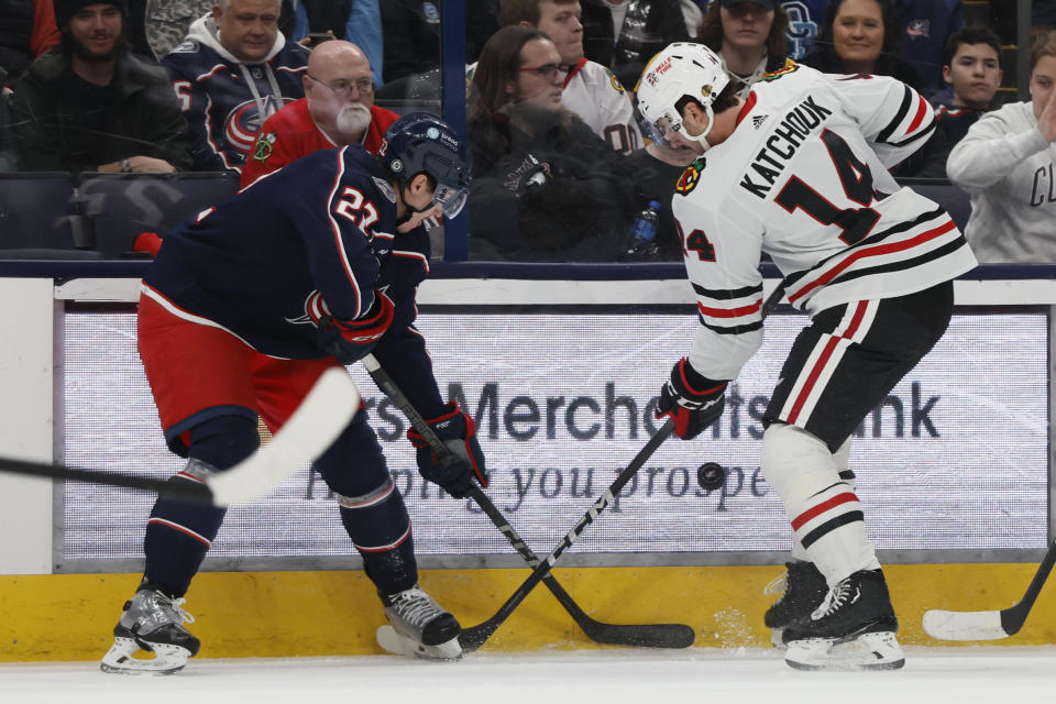 Columbus Blue Jackets' Jake Bean, left, and Chicago Blackhawks' Boris Katchouk compete for the puck during the third period of an NHL hockey game Wednesday, Nov. 22, 2023, in Columbus, Ohio. (AP Photo/Jay LaPrete)
