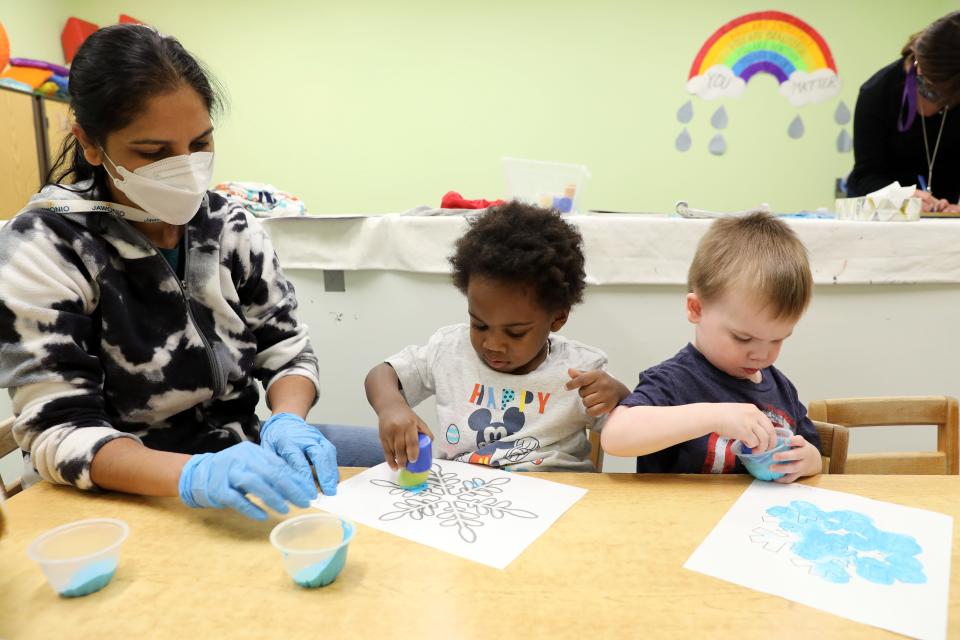 Teaching assistant Sushma Mhatre works with Jayden and Hugh as they paint snowflakes during early intervention class at Jawonio in New City March 2, 2023.