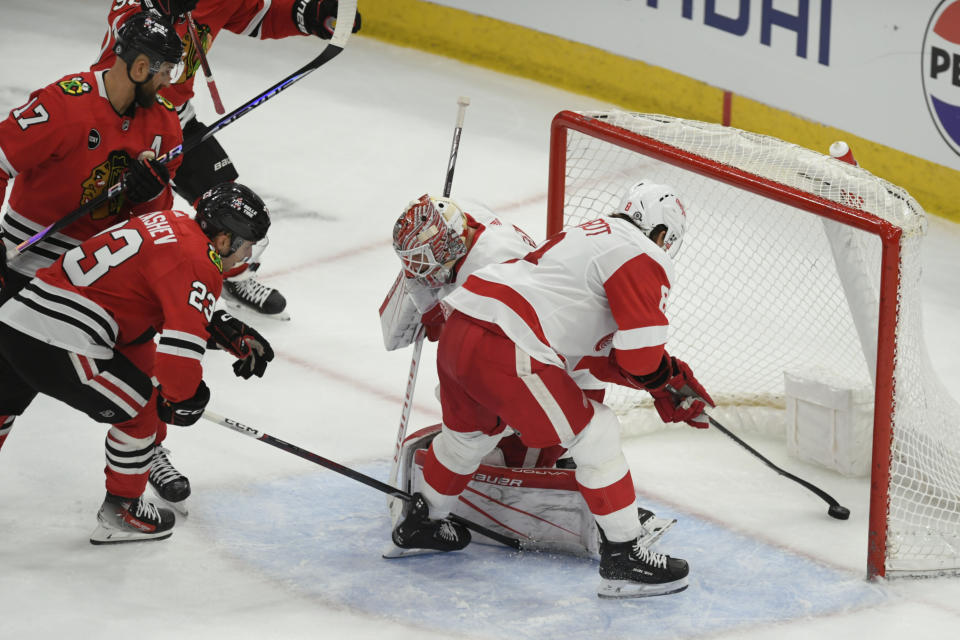 Detroit Red Wings' Ben Chiarot (8) and goalie James Reimer (47) attempt to stop a goal scored by Chicago Blackhawks' Nick Foligno (17) during the second period of an NHL hockey game Sunday, Feb. 25, 2024, in Chicago. (AP Photo/Paul Beaty)