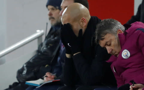 Guardiola has his hands in his head - Credit: Reuters