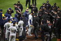 Members of the Baltimore Orioles and Milwaukee Brewers gather at the home plate area after the benches cleared during the sixth inning of a baseball game Friday, April 12, 2024, in Baltimore. (AP Photo/Nick Wass)