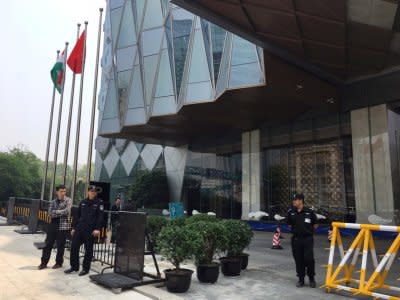 Police officers are seen next to Chinese and Indian flags outside a hotel in Wuhan, Hubei province, China April 27, 2018. REUTERS/Sue-Lin Wong