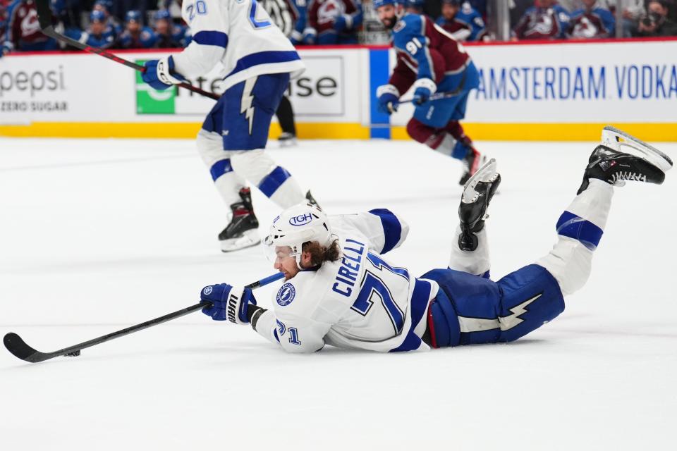 Tampa Bay Lightning center Anthony Cirelli (71) works the puck from in the ice, against the Colorado Avalanche during the second period in Game 5 of the NHL hockey Stanley Cup Final, Friday, June 24, 2022, in Denver. (AP Photo/Jack Dempsey)