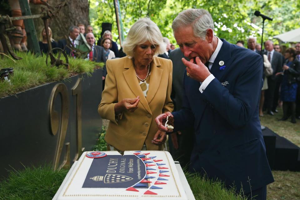 Let them eat cake? Prince Charles, Prince of Wales and Camilla, Duchess of Cornwall cut a cake to celebrate the 21st anniversary of Duchy originals products at Clarence House on September 11, 2013 in London, England.