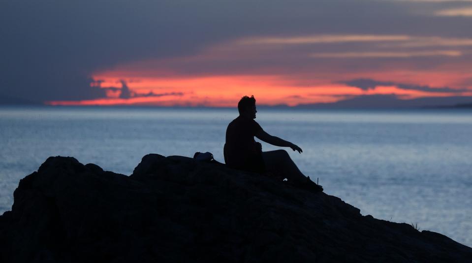 A man watches the sunset over the Great Salt Lake from Ladyfinger Point on Antelope Island on Monday, June 5, 2023. | Kristin Murphy, Deseret News